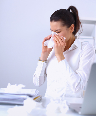 BM_Young-businesswoman-blowing-her-nose,-sits-at-the-desk77258852