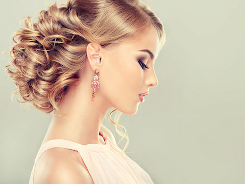 Beautiful model with elegant hairstyle . Beautiful woman with fashion wedding hairstyle and colourful makeup
