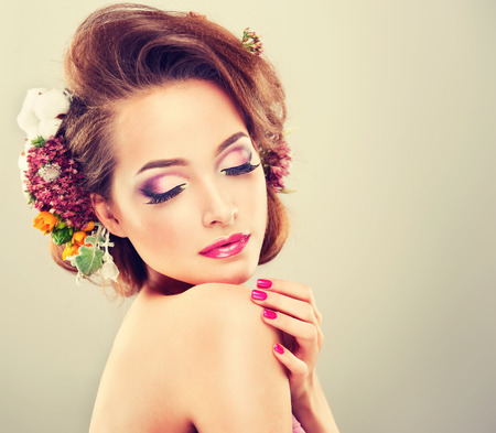 37720519 - spring freshness. girl with delicate pastel flowers in curly hair