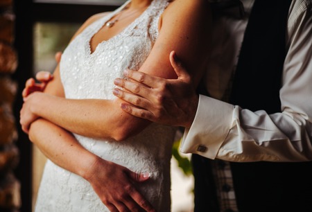 44973603 - the hand of the groom gently embraces the bride