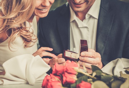 29540088 - man holding box with ring making propose to his girlfriend