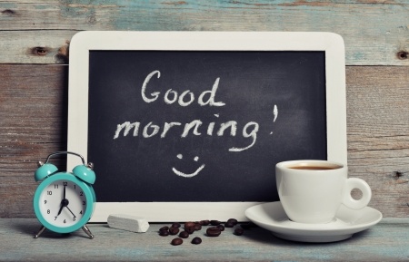 23775776 - cup of coffee with blackboard and alarm clock on vintage wooden background